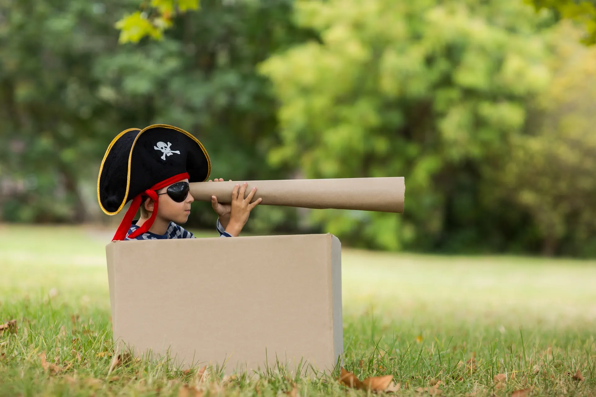 Child playing in a cardboard box